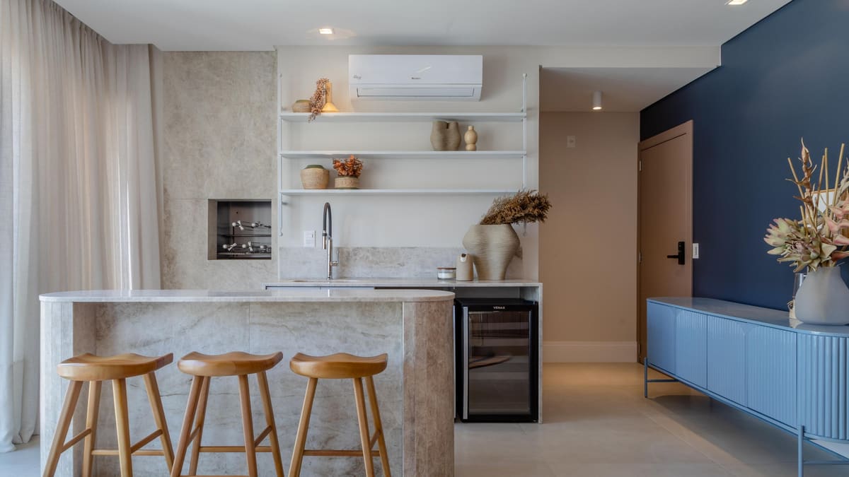 Stone-clad bar counter with wood stools, open shelving and a wine cooler