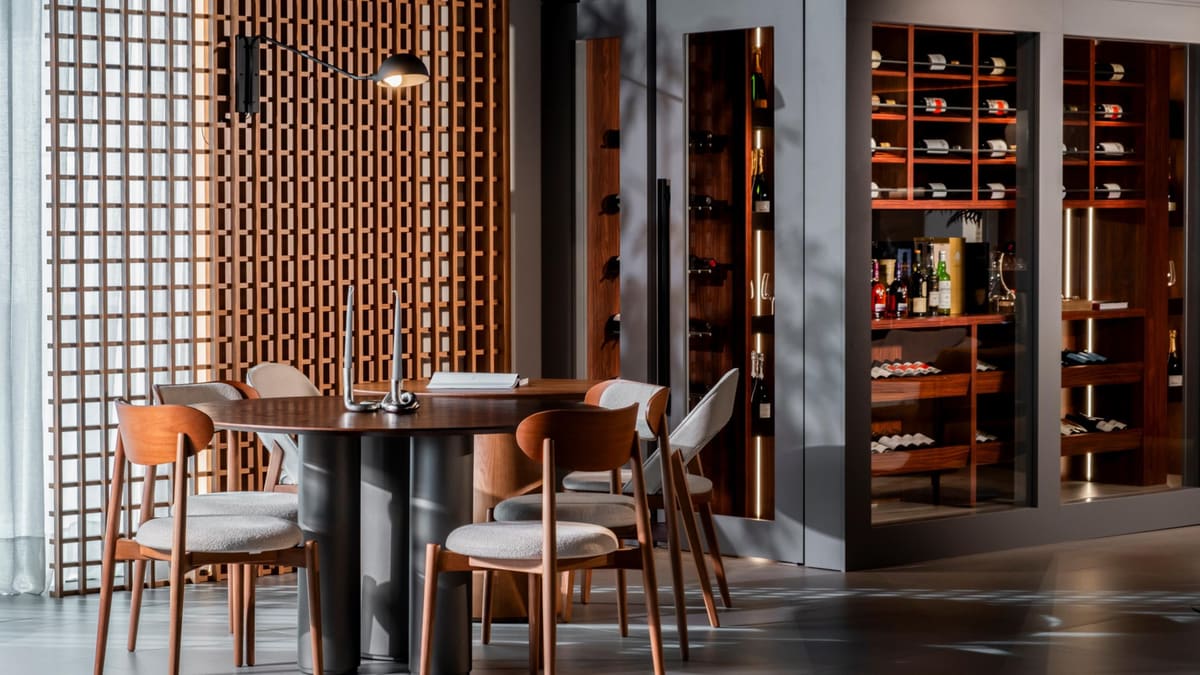Dining area beside a wood lattice screen, with a walk-in wine room beyond